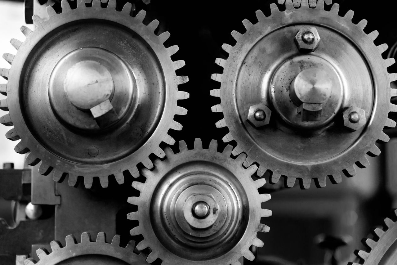 Detailed black and white image of interlocking metal gears showcasing industrial mechanics.